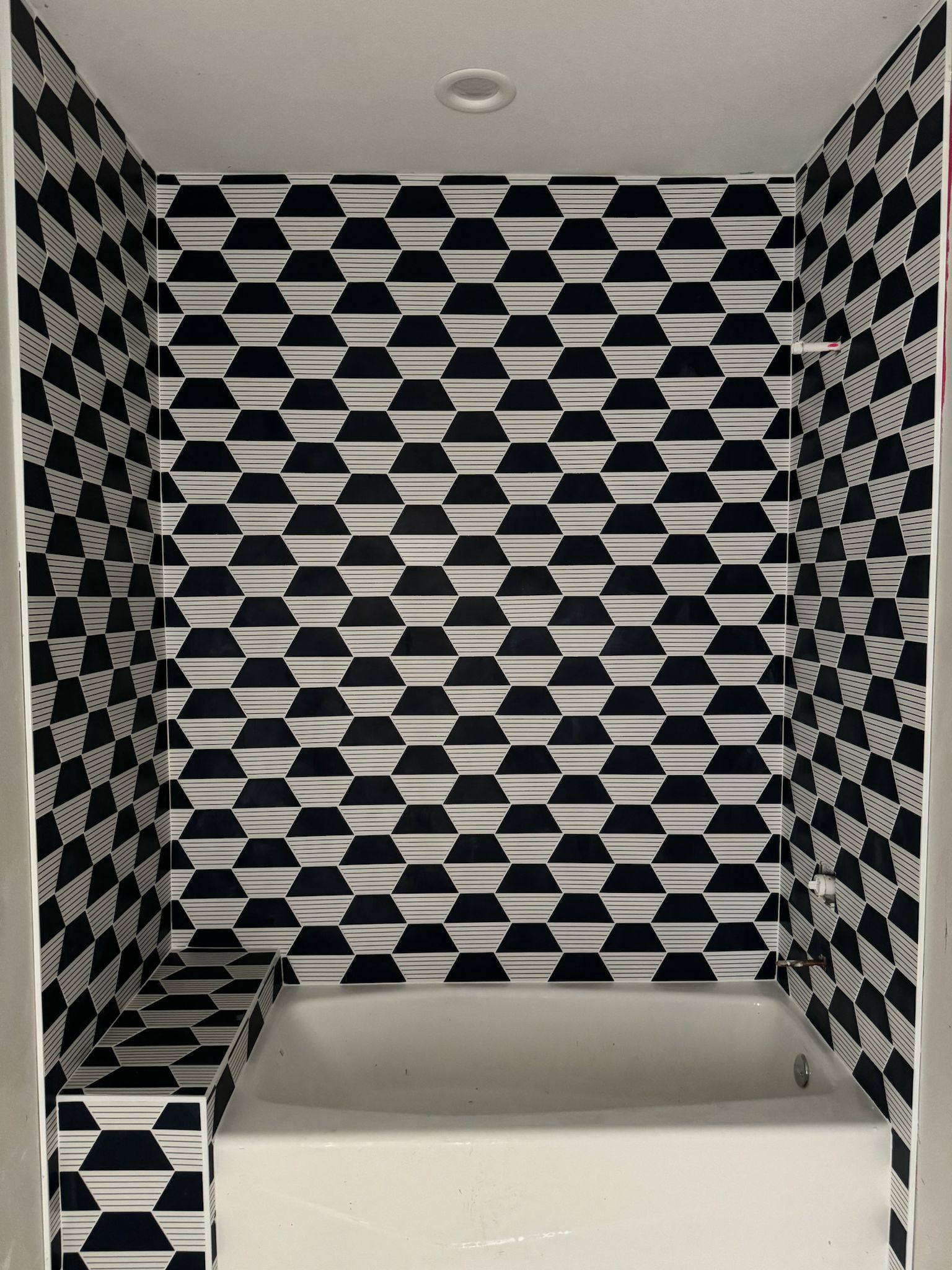 Navy and white geometric tile shower and backsplash