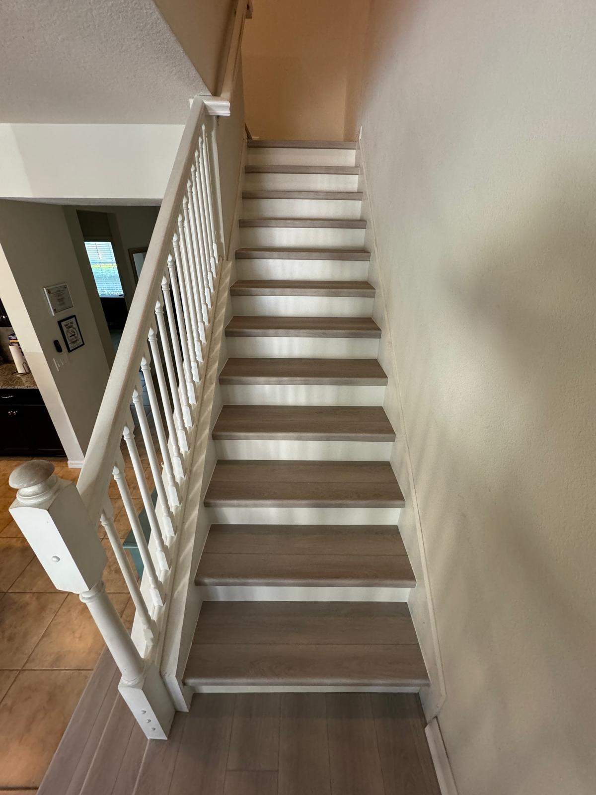 Finished wood stair treads with clean risers and trim