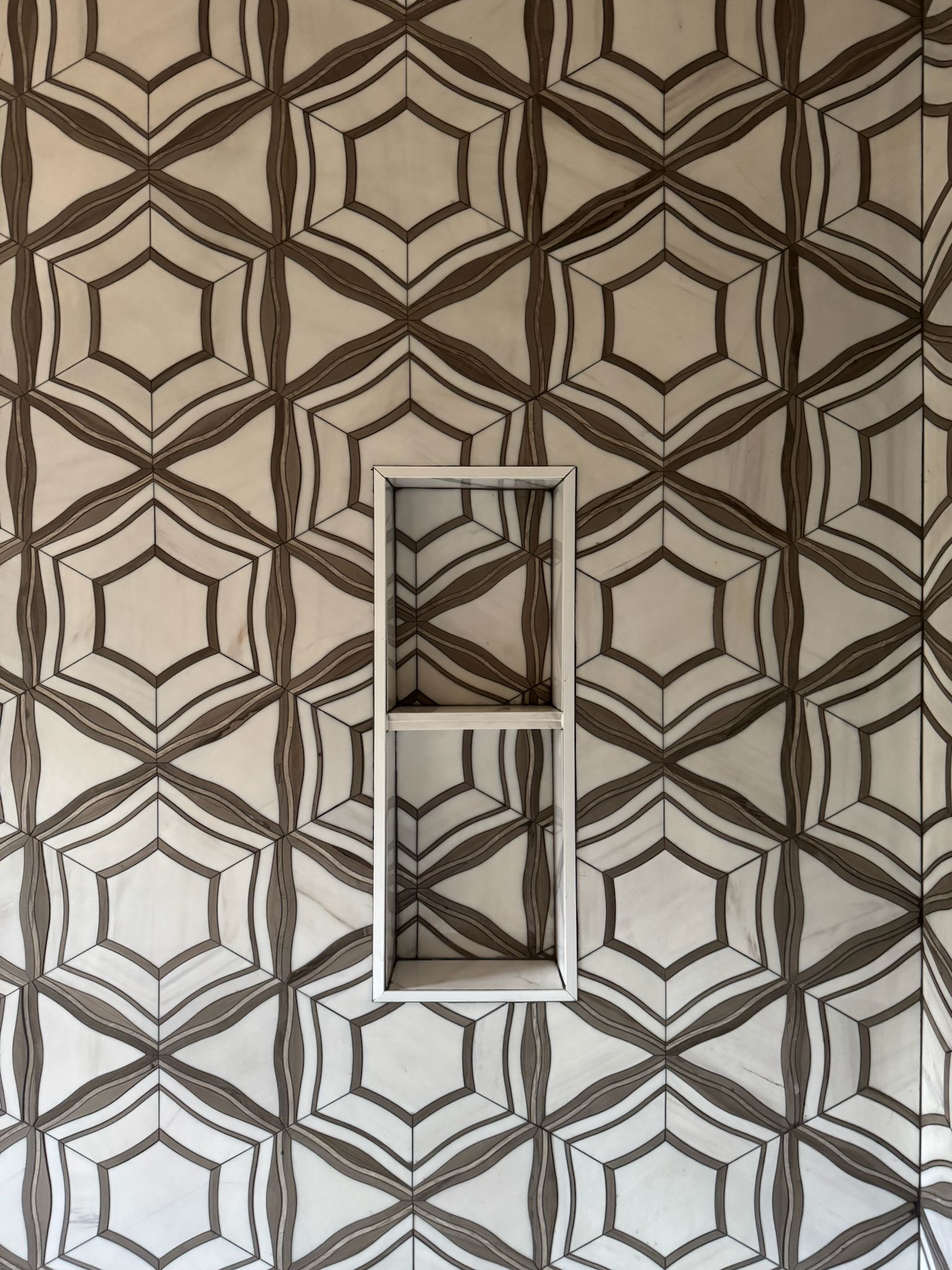 White and walnut marble star-pattern tile feature wall